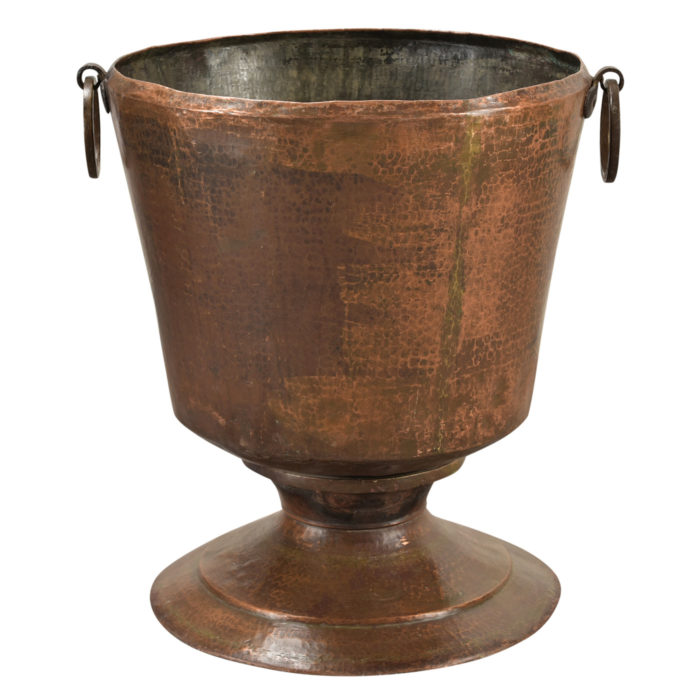 An antique hammered copper pot that is handmade from India and available at AOI Home.
