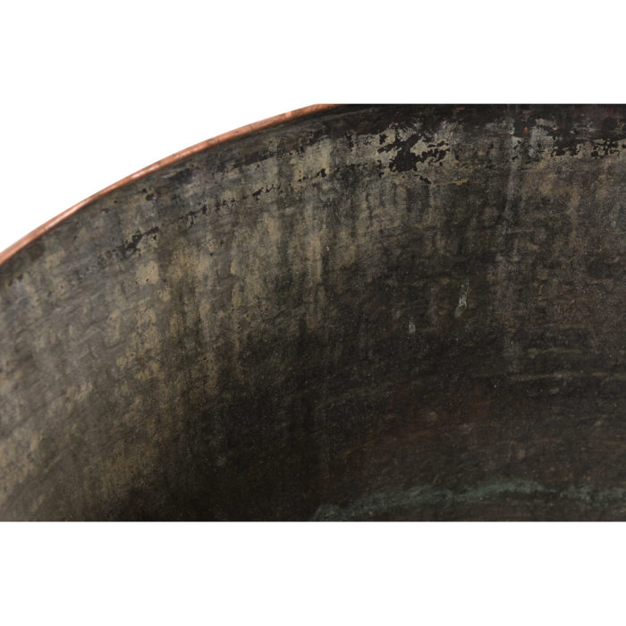 An antique hammered copper pot that is handmade from India and available at AOI Home.