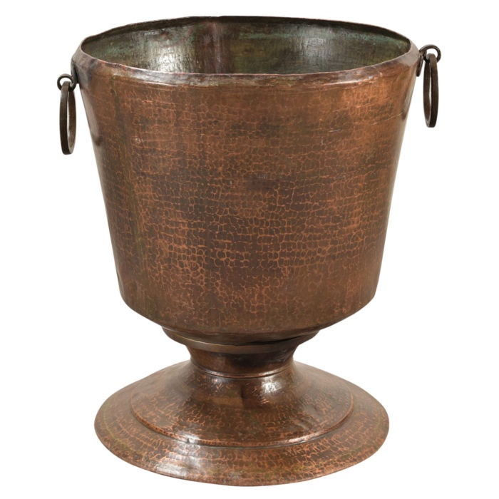 An antique hammered copper pot that is handmade from India and available at AOI Home.
