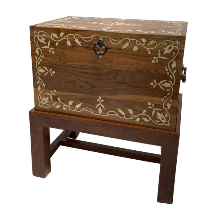 A bone inlay box on a wooden stand from the Dallas design showroom AOI Home.