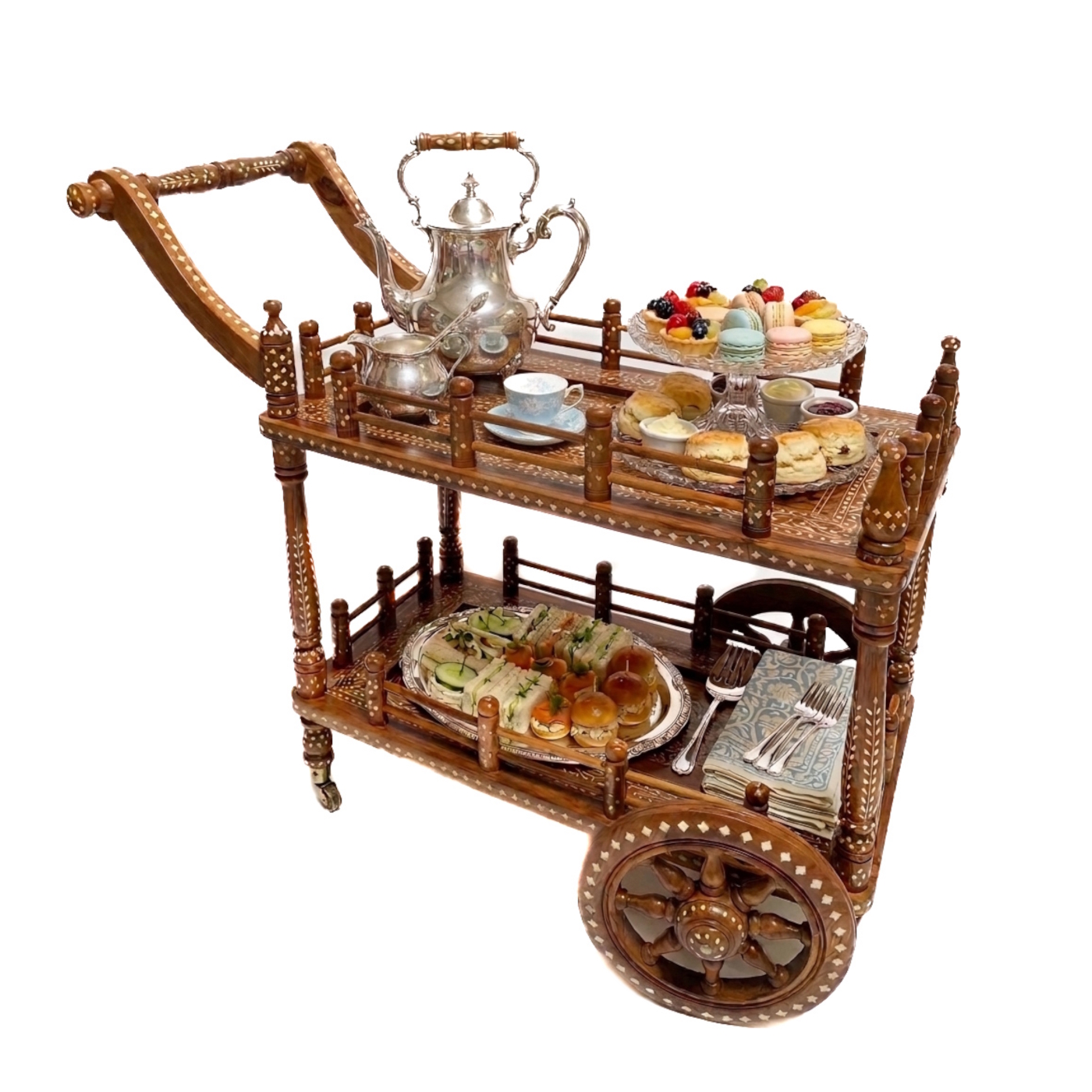 Two-tiered bone inlay teak wood tea trolley cart styled for high tea with spoked wheels, spindle railings, and intricate floral and geometric inlay patterns.