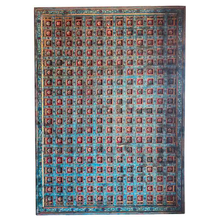 A hand-carved panel with delicate blue and gold flowers from the interior designer showroom AOI Home.