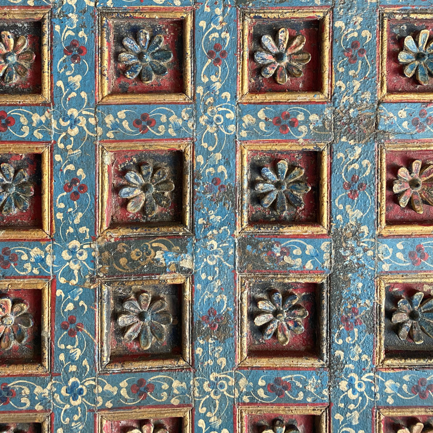 A hand-carved panel with delicate blue and gold flowers from the interior designer showroom AOI Home.