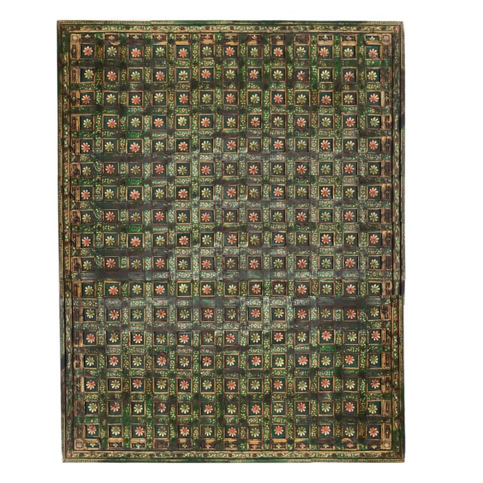 A hand-carved antique ceiling panel with green and gold flowers from AOI Home.