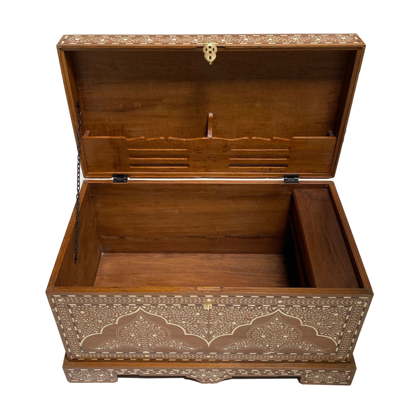 A bone inlay trunk for the foot of the bed by the luxury design showroom AOI Home.