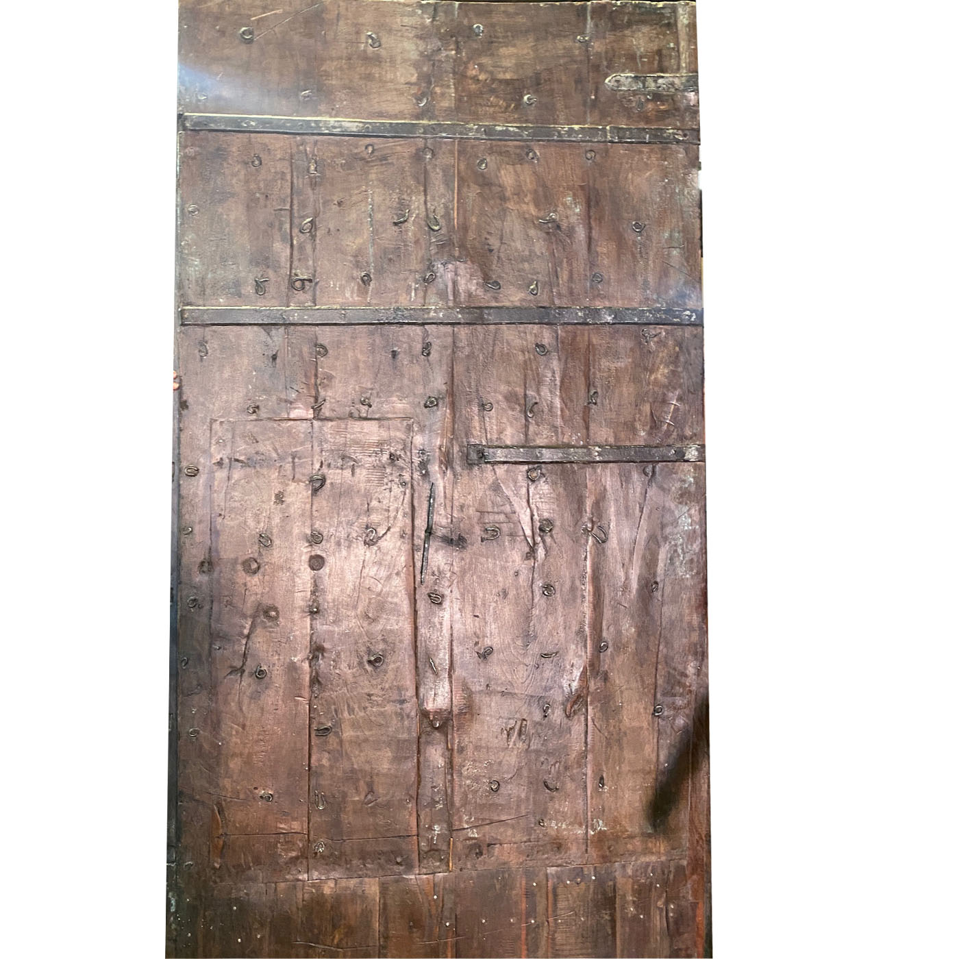 A large antique Indian door with fine details from the Dallas showroom AOI Home.