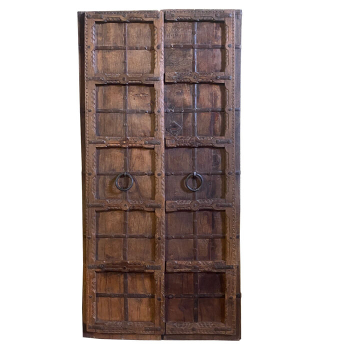 A charming carved antique door from India available at AOI Home in Dallas.