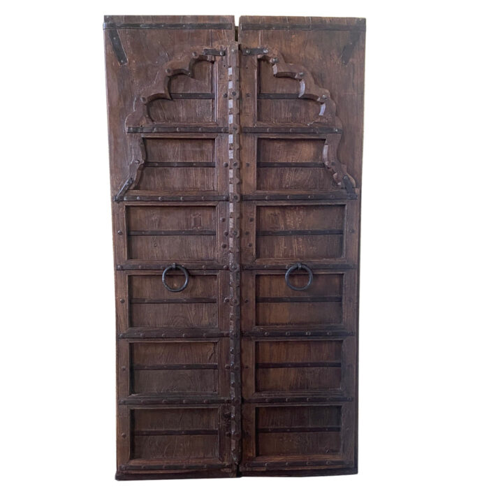 A carved antique wooden Indian door from the interior design showroom AOI Home.