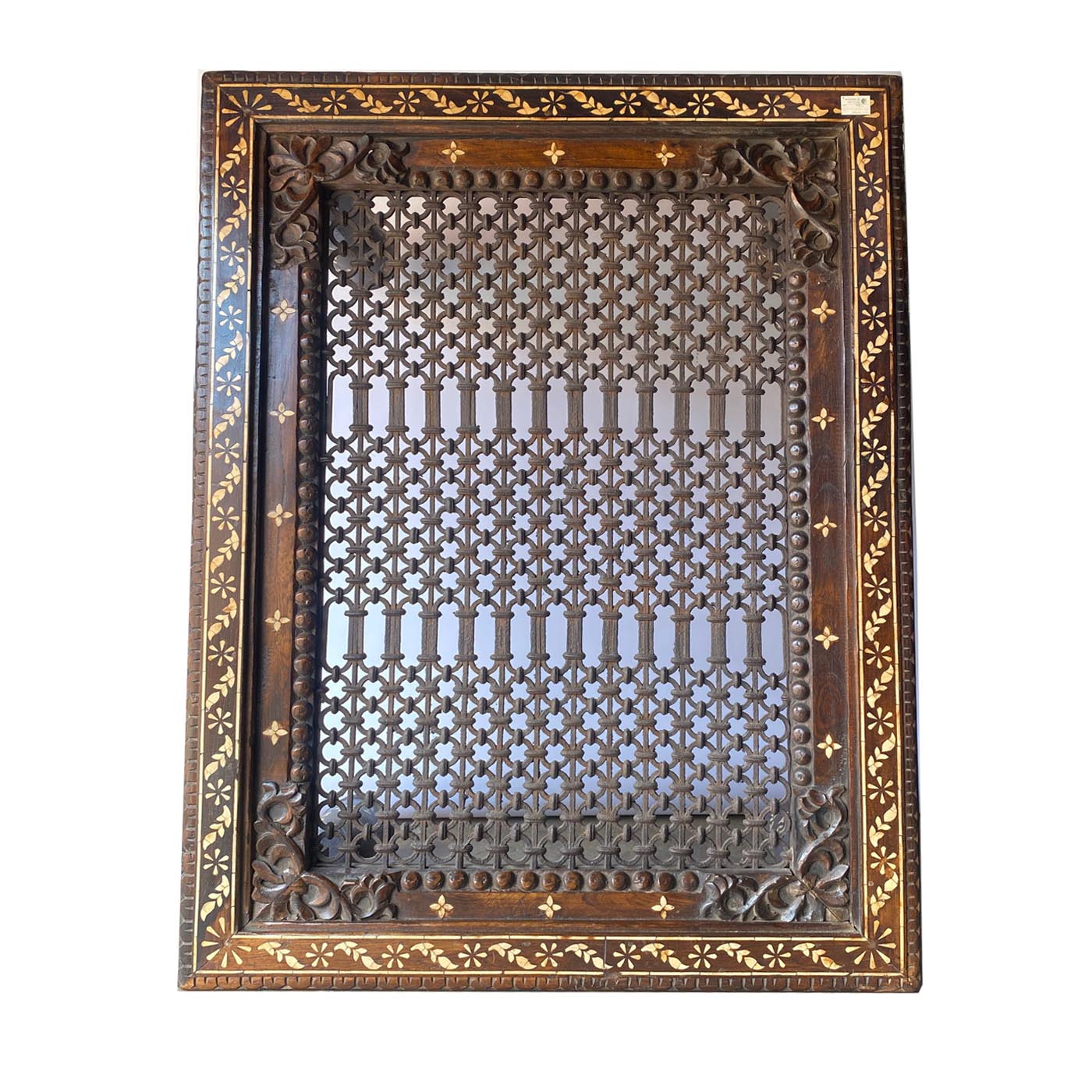 A rectangular coffee table with bone inlay and a iron grill top from the design shop AOI Home.